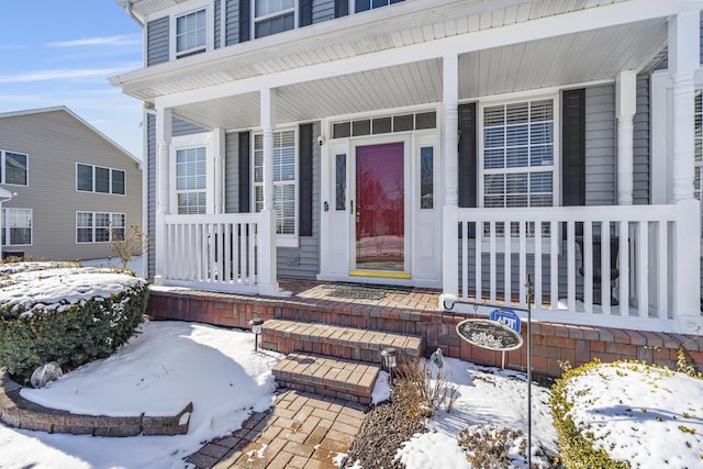 view of snow covered property entrance