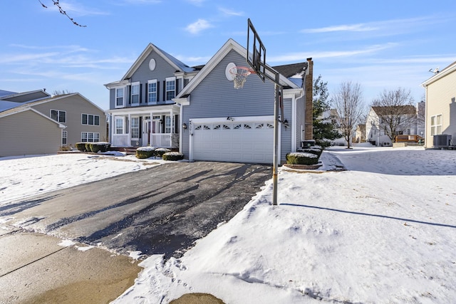 front facade with a garage and central AC unit