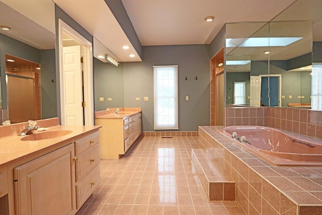 full bathroom featuring a garden tub, a stall shower, two vanities, and a sink