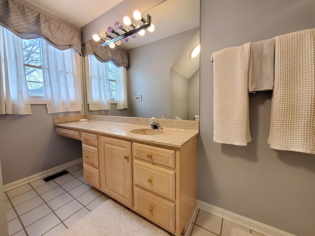 bathroom with vanity, tile patterned flooring, visible vents, and baseboards