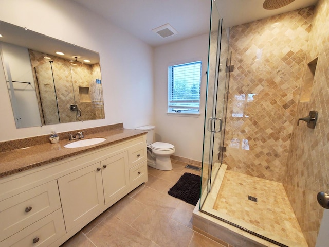 bathroom featuring a stall shower, visible vents, vanity, and tile patterned floors