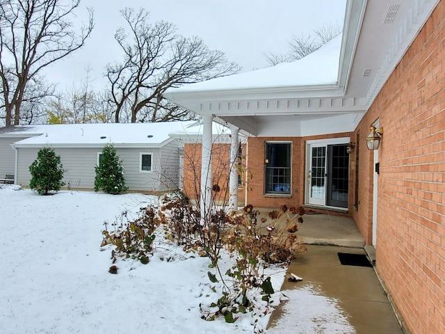 yard covered in snow with visible vents