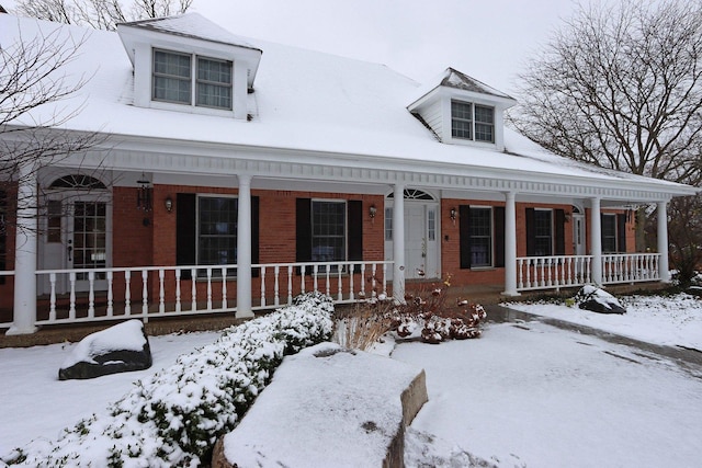 view of front facade featuring a porch and brick siding