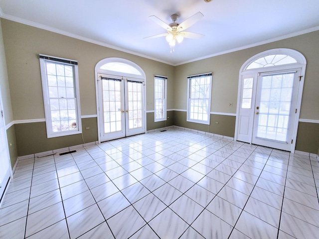 interior space featuring light tile patterned floors, ceiling fan, crown molding, and french doors