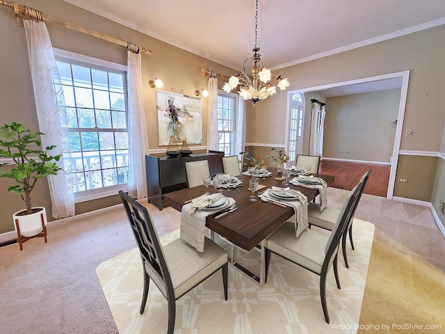 dining room featuring baseboards, ornamental molding, a chandelier, and light colored carpet