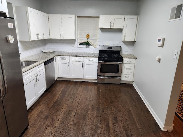 7715 S Paxton Ave, Chicago, IL 60649 - kitchen featuring appliances with stainless steel finishes, white cabinets, backsplash, and dark wood-type flooring
