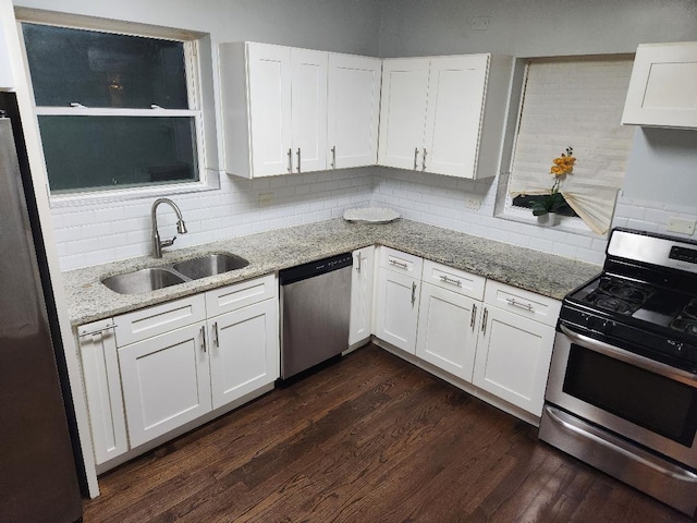 7715 S Paxton Ave, Chicago, IL 60649 - kitchen featuring stainless steel appliances, a sink, tasteful backsplash, and white cabinetry