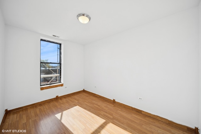 unfurnished room with hardwood / wood-style floors