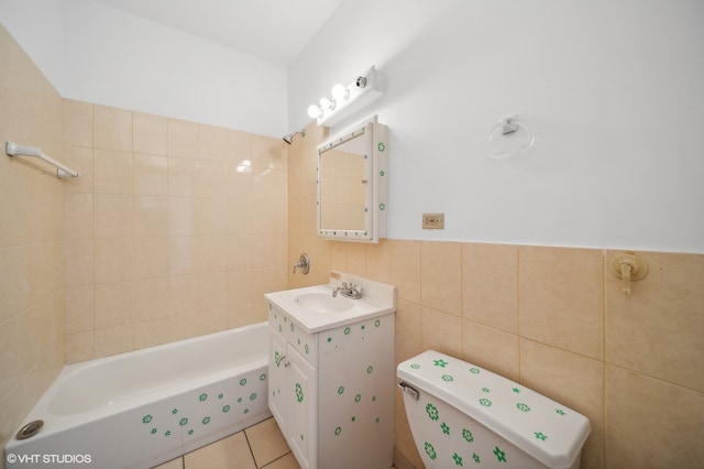 bathroom with tile patterned flooring, vanity, toilet, and tile walls