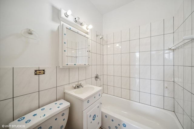 bathroom with vanity, tile walls, and toilet