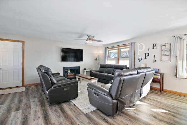 living room with ceiling fan and wood-type flooring