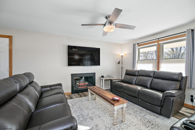 living room with ceiling fan and light wood-type flooring