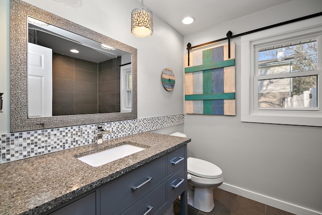 bathroom with decorative backsplash, vanity, and toilet