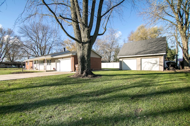 view of yard featuring a garage and an outdoor structure