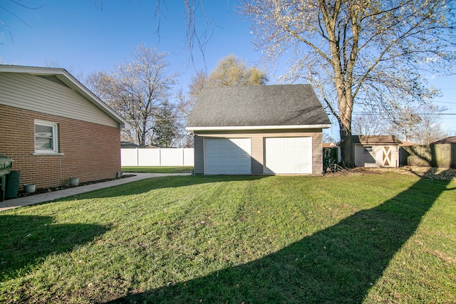 view of yard with a garage and a shed