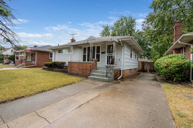 bungalow-style house with covered porch and a front lawn