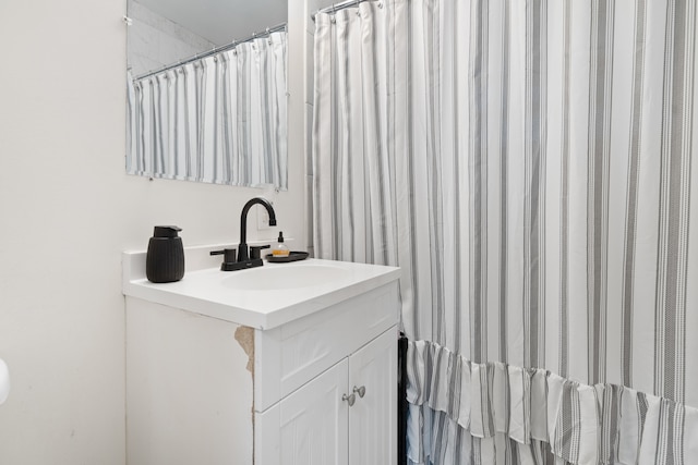 bathroom featuring vanity and curtained shower