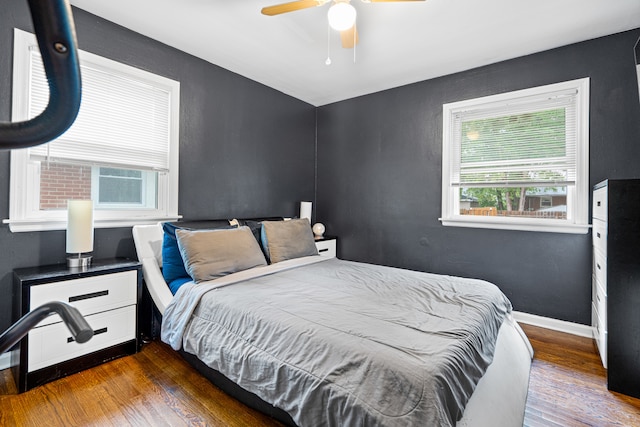 bedroom featuring ceiling fan and dark hardwood / wood-style flooring