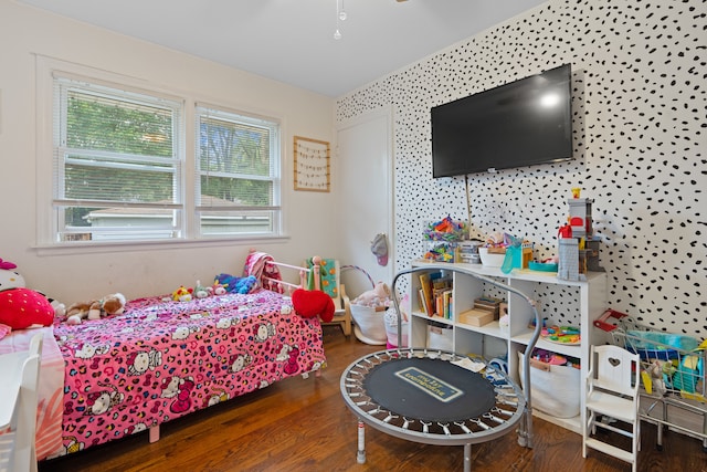 bedroom with dark hardwood / wood-style flooring