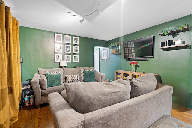 living room with wood-type flooring and rail lighting