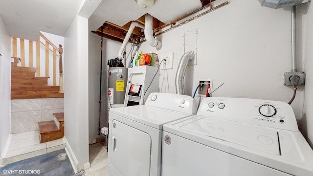 laundry area featuring light tile patterned flooring and washing machine and dryer