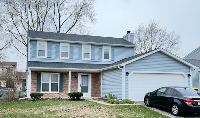 front of property featuring a front lawn and a garage