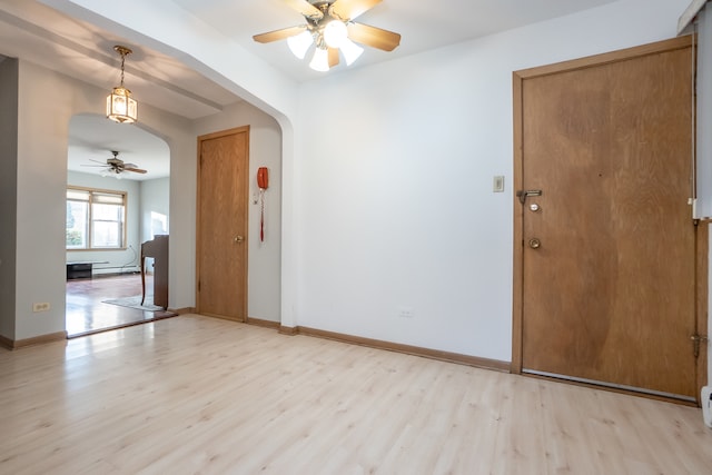 unfurnished room with ceiling fan and light wood-type flooring