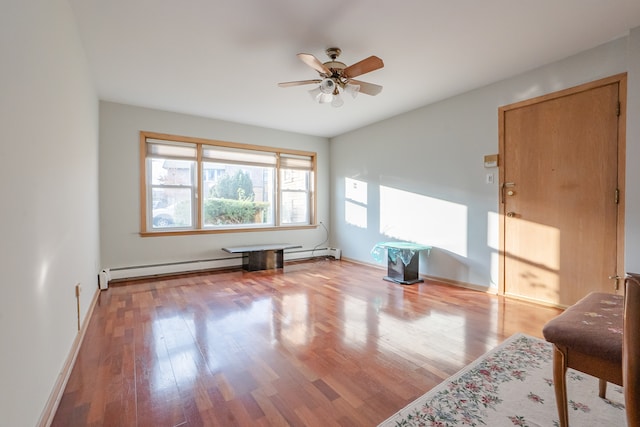 interior space featuring ceiling fan, light hardwood / wood-style floors, and a baseboard radiator