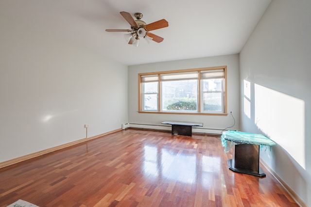 spare room with hardwood / wood-style floors and ceiling fan