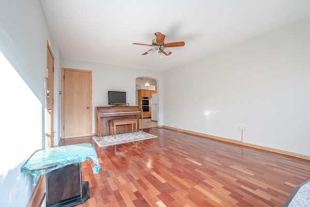 living room with hardwood / wood-style floors and ceiling fan