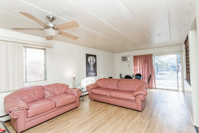 living room with a wall mounted AC, a baseboard heating unit, ceiling fan, and light hardwood / wood-style flooring