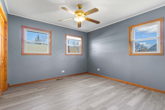 spare room featuring ceiling fan, light hardwood / wood-style floors, and ornamental molding