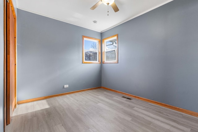 empty room featuring light hardwood / wood-style floors, ceiling fan, and crown molding