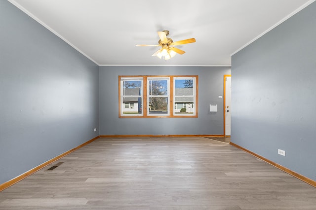 spare room featuring light hardwood / wood-style floors, ceiling fan, and crown molding