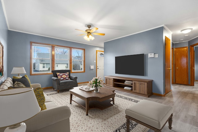 living room with light hardwood / wood-style floors, ceiling fan, and crown molding