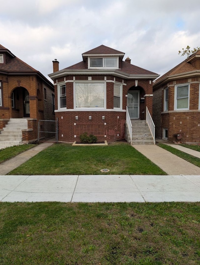 bungalow-style home featuring a front yard