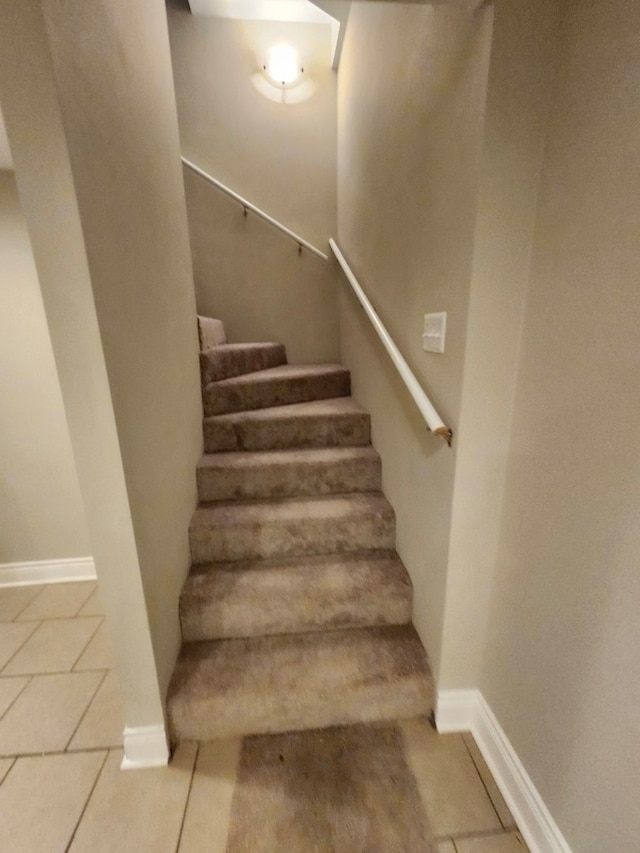 stairway featuring tile patterned floors