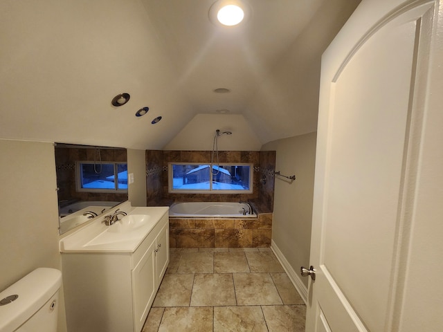 bathroom featuring vanity, toilet, lofted ceiling, and tiled tub