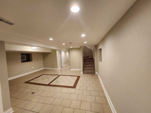 basement featuring light tile patterned floors