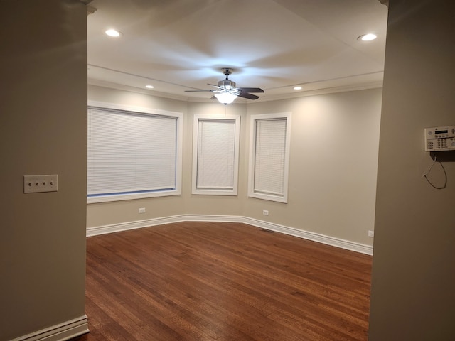 spare room with ceiling fan, dark hardwood / wood-style floors, and ornamental molding