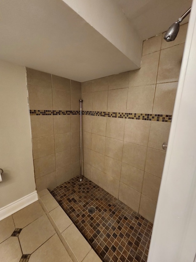 bathroom with tile patterned flooring and tiled shower