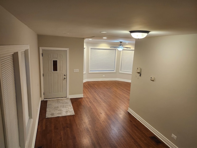 interior space featuring ceiling fan and dark wood-type flooring