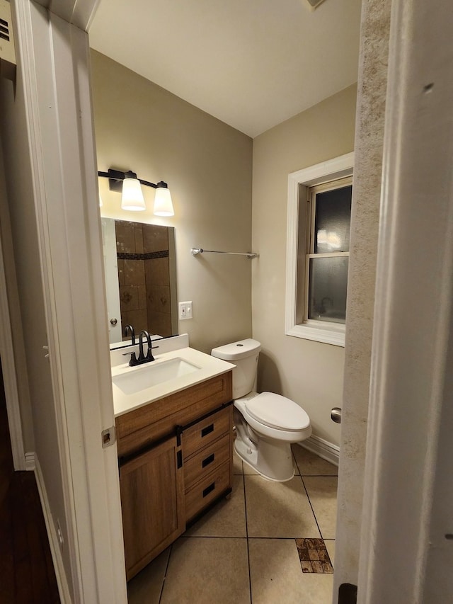 bathroom featuring tile patterned floors, vanity, and toilet