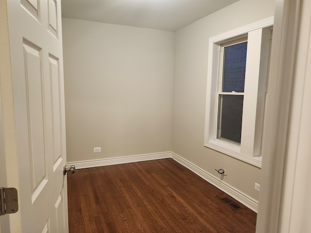 unfurnished room featuring dark hardwood / wood-style flooring