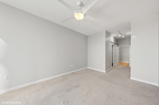 unfurnished room with ceiling fan and light colored carpet