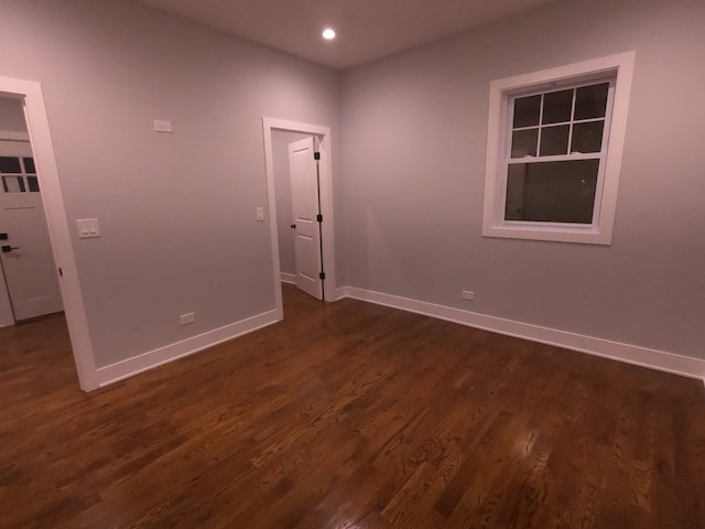 unfurnished room featuring dark wood-type flooring