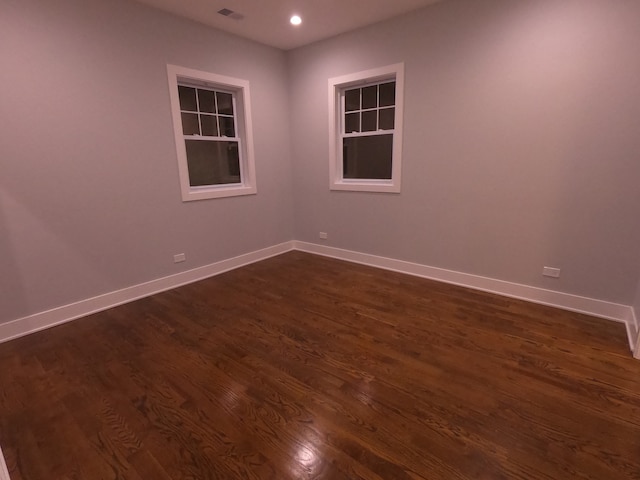 empty room featuring dark wood-type flooring