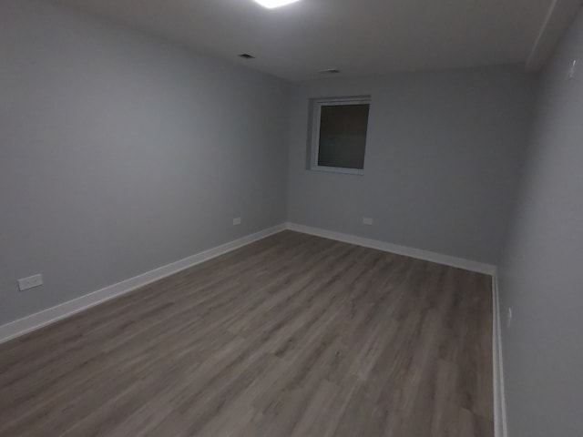 empty room with hardwood / wood-style floors