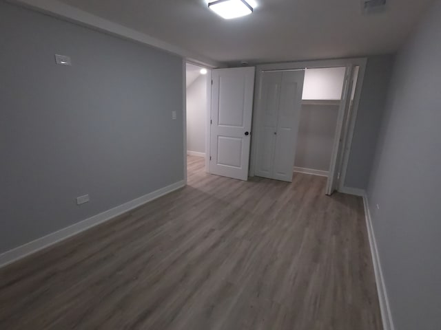 unfurnished bedroom featuring hardwood / wood-style floors and a closet