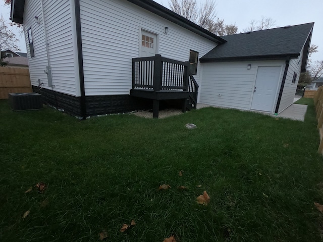 back of property featuring a lawn and central AC unit